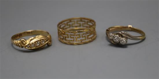 An 18ct gold five-stone diamond ring, a similar three-stone ring and a Greek Key patterned ring (tests as 9ct)